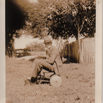 John Henry in a Hat riding a Tricycle