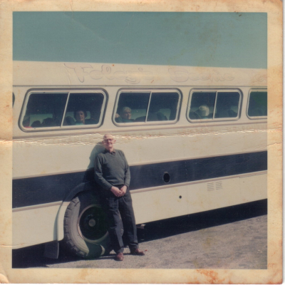 William Gallen Standing in Front of Bus