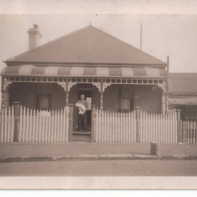 William Gallen Standing in Front of House